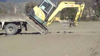 Loading an excavator onto a truck without ramps [upl. by Irec]